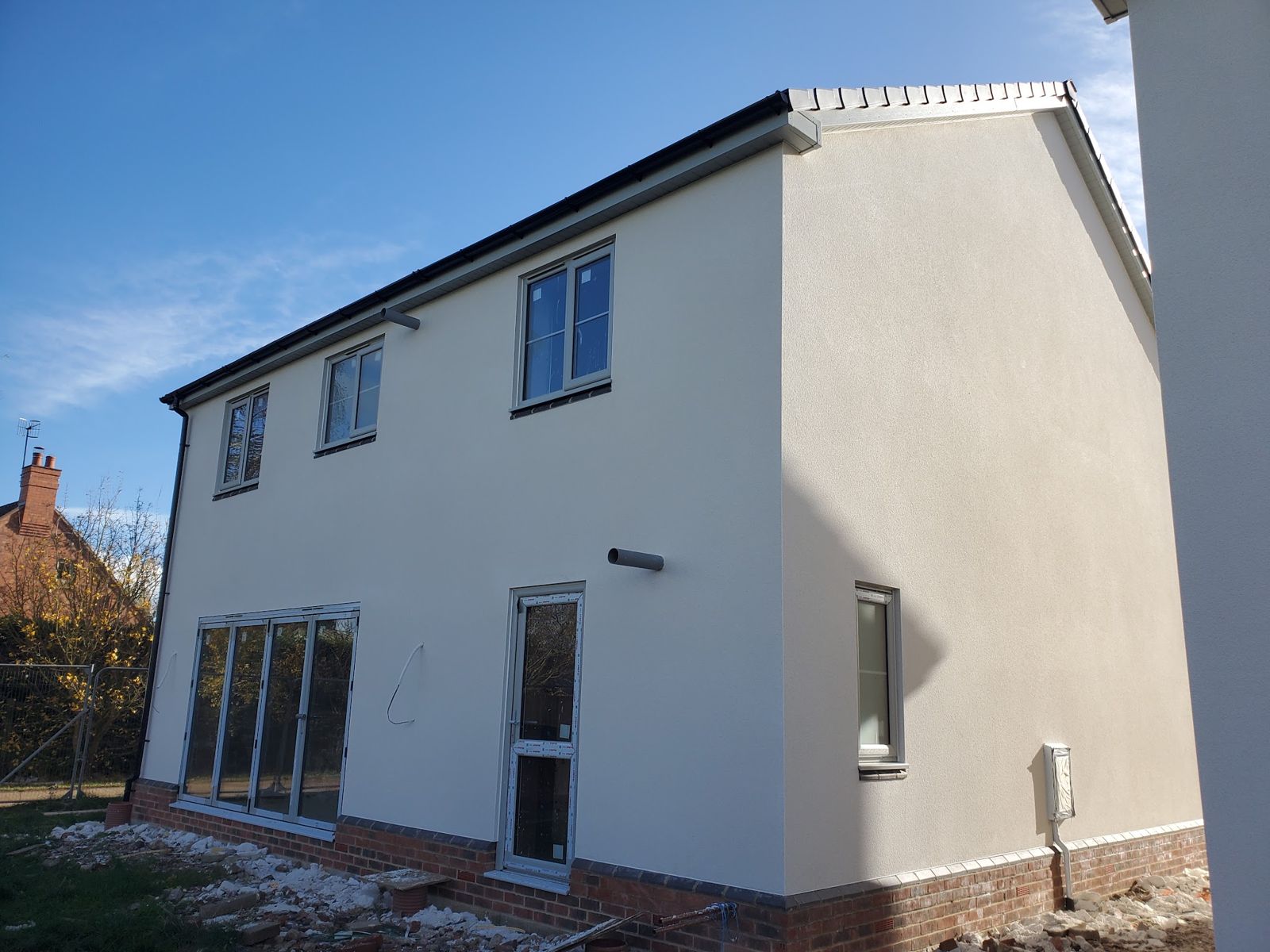 A two-storey house finished in off-white render