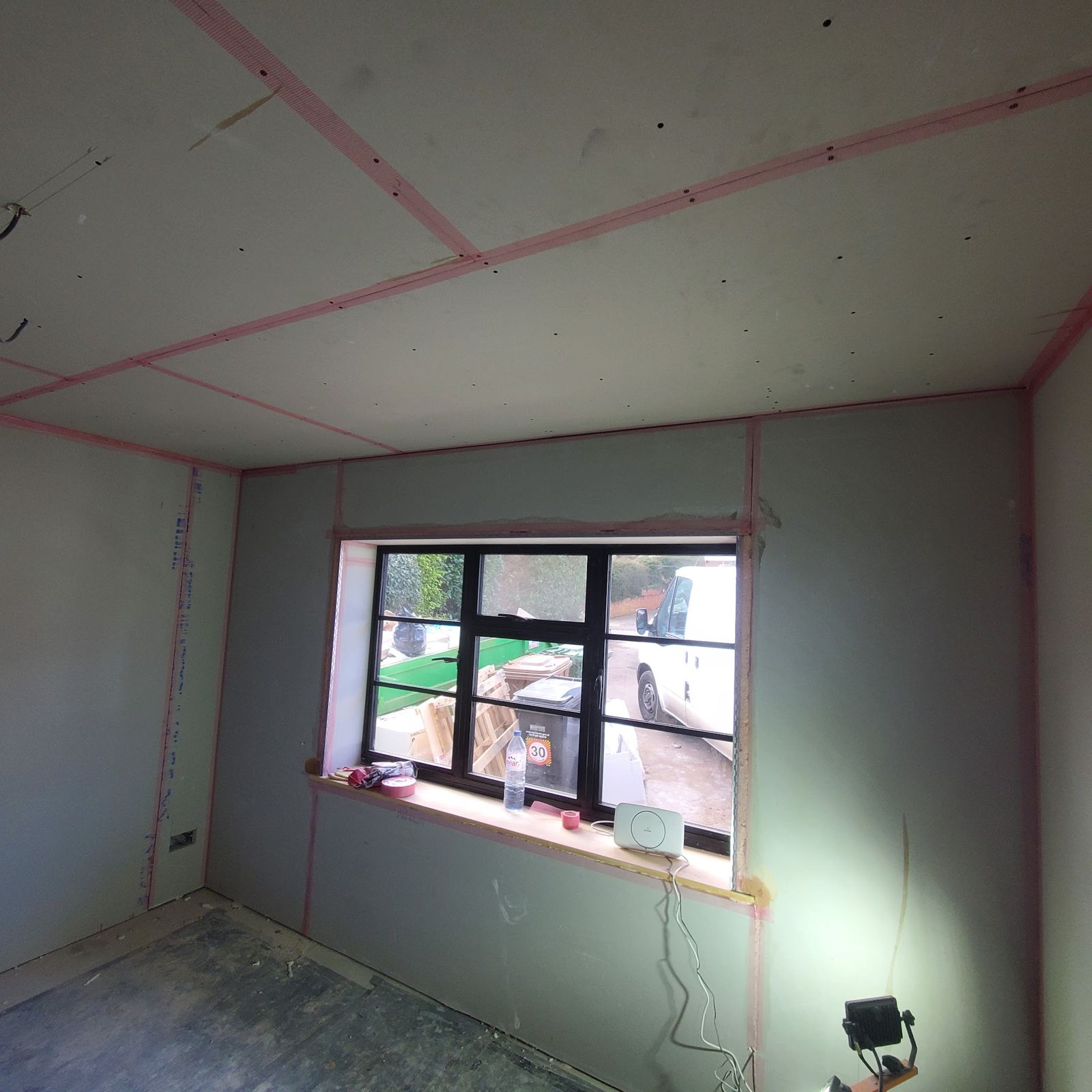 A room boarded out in plasterboard with scrim tape on every joint
