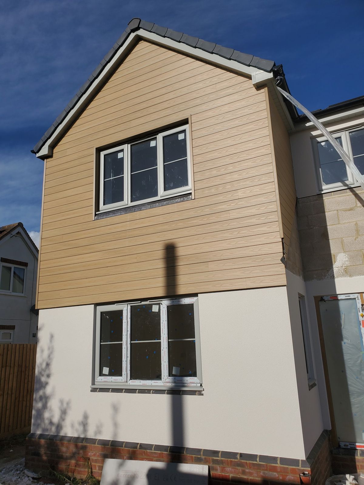 A house with render below a timber-clad gable