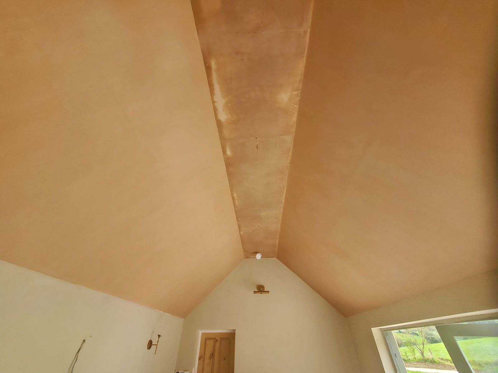 A double vaulted ceiling skimmed in two coats of multifinish