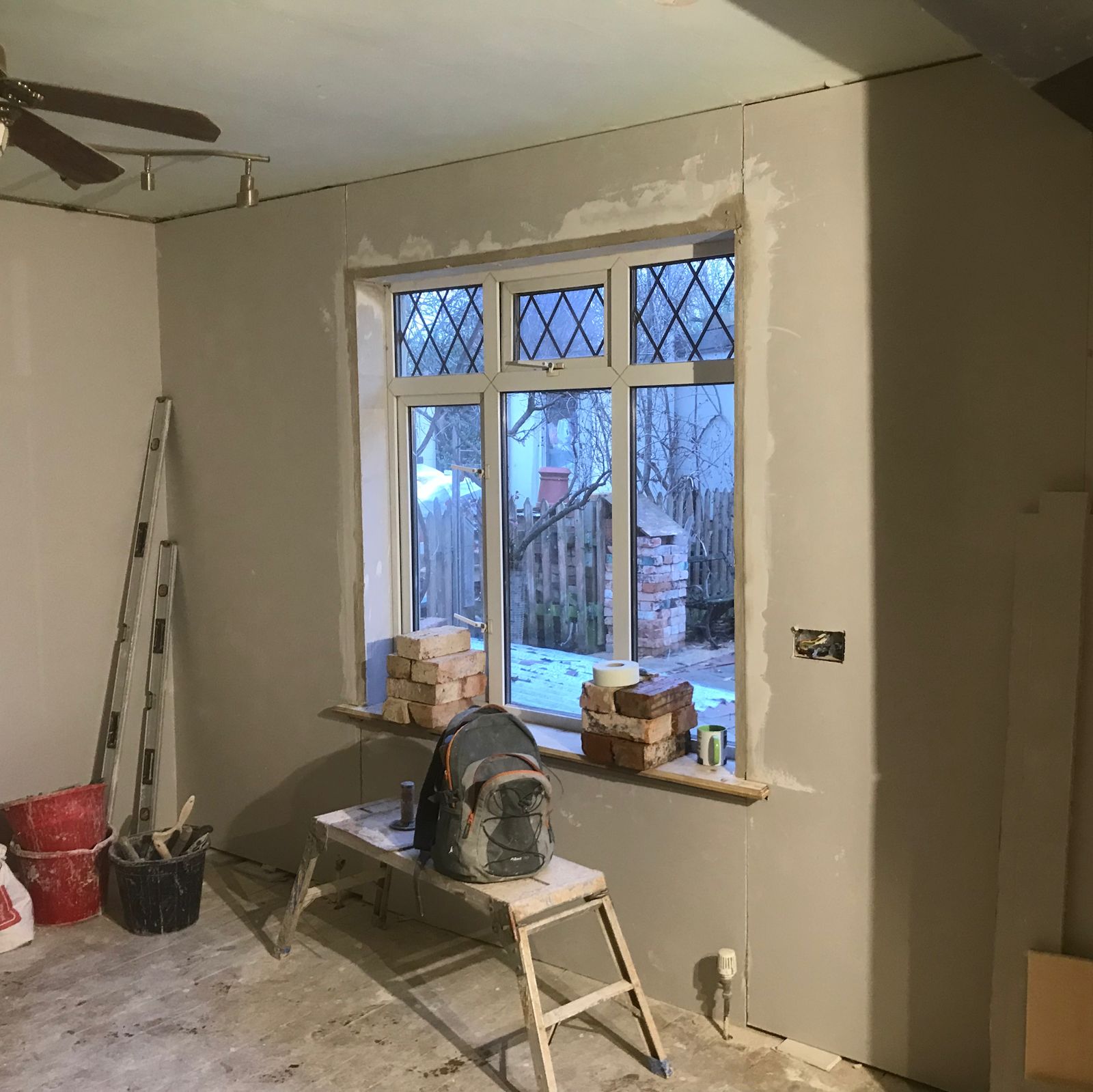 Insulated plasterboard fixed round a leaded window, ready for plastering