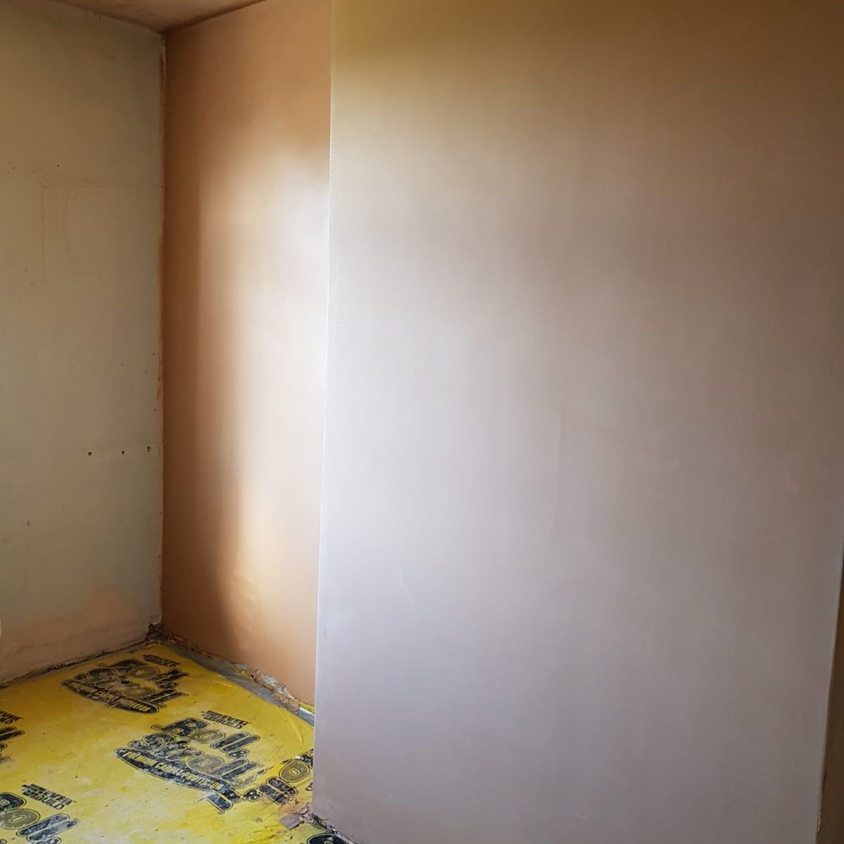 Freshly plastered cottage walls drying pink