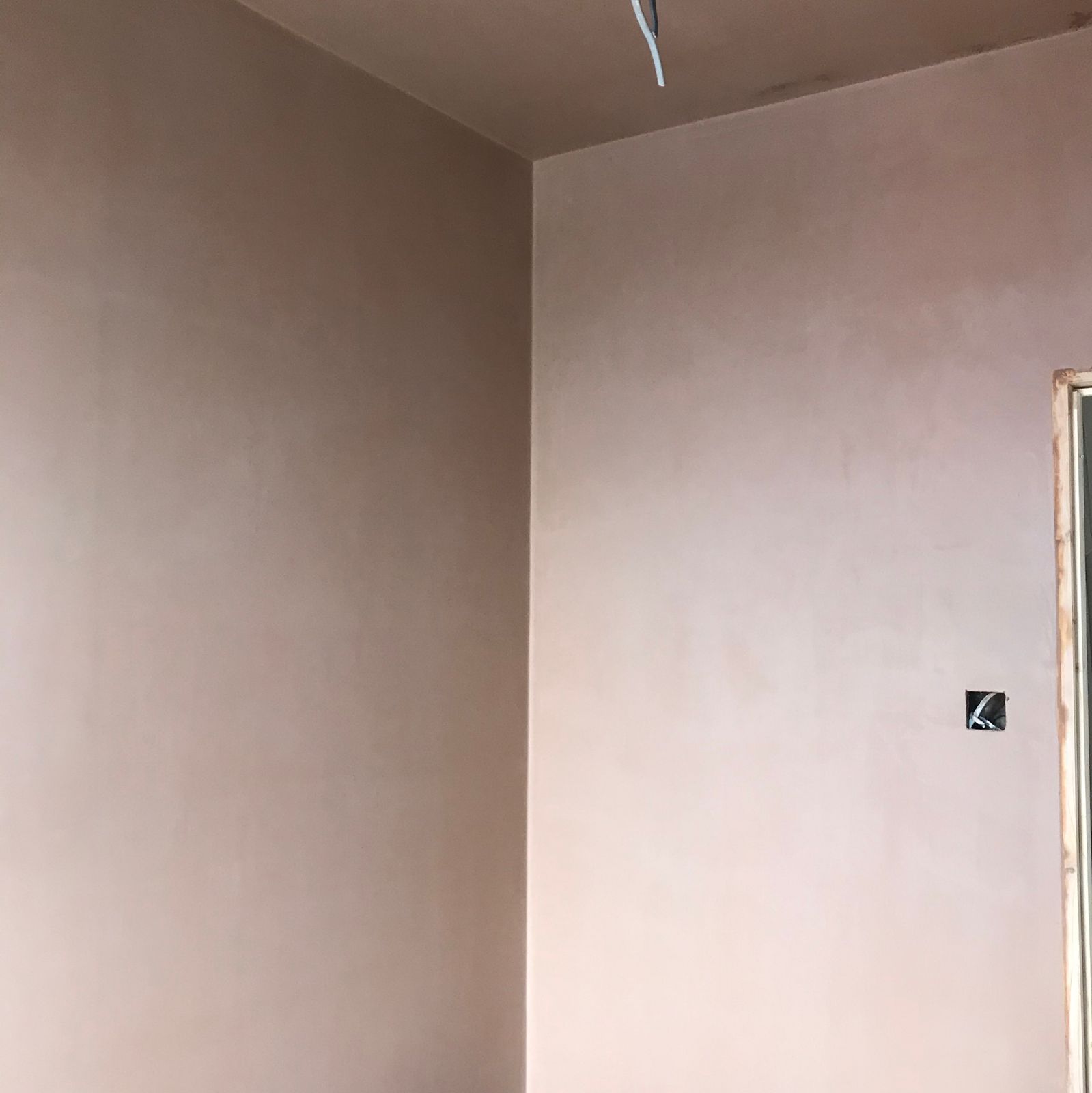 Fresh plaster on two walls meeting in a corner