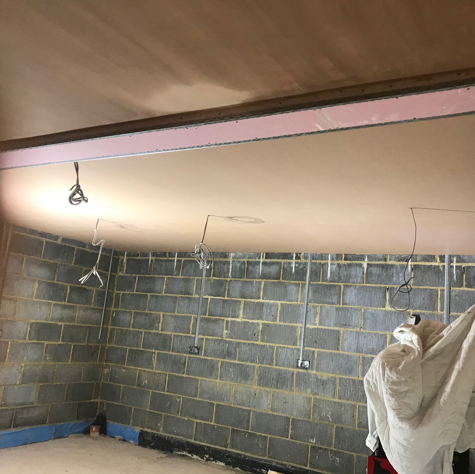 Blockwork walls under a freshly boarded ceiling, ready for float and set