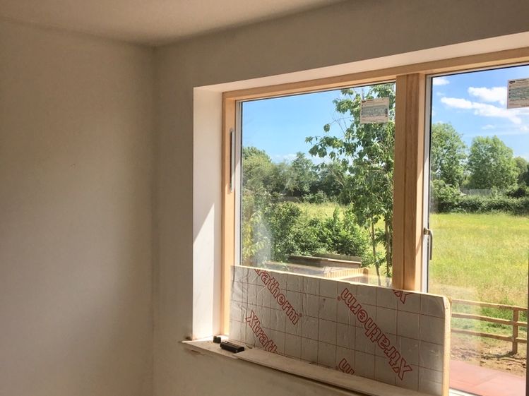 A plastered window reveal looking out over fields
