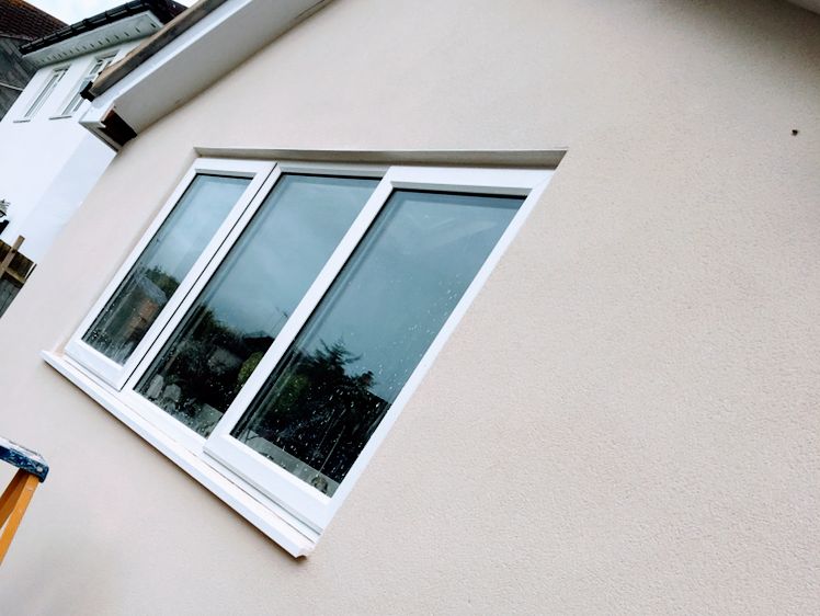 White K-Rend on an exterior wall round a three-pane window